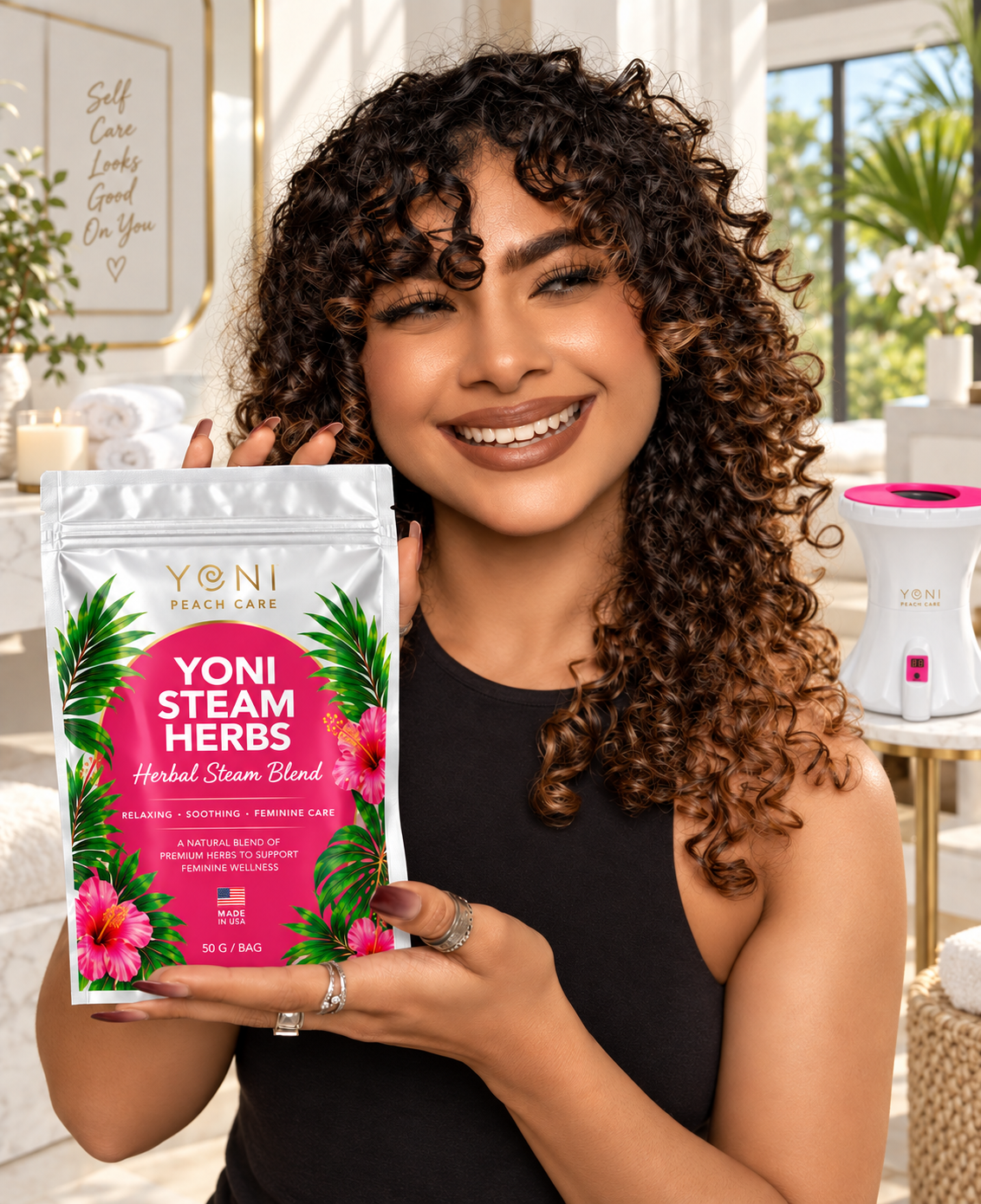 Smiling woman holding a Yoni Steam Herbs pouch with the V-Pot steamer in the background