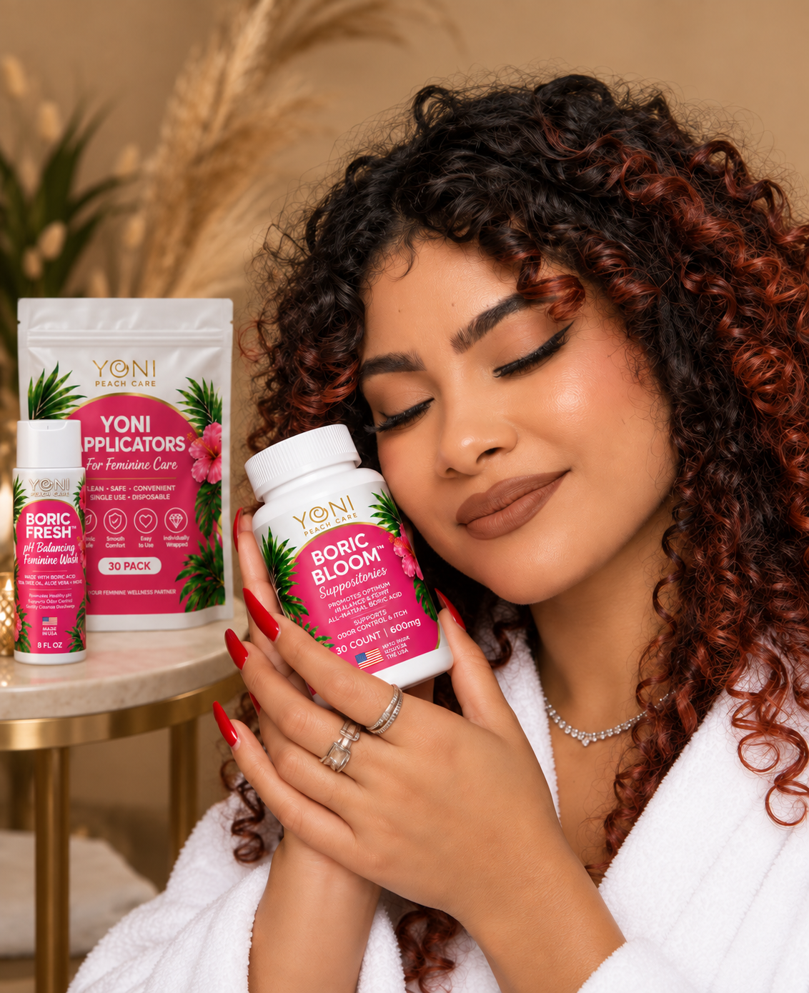 Woman cradling Boric Bloom suppositories with Boric Fresh wash and applicators behind her
