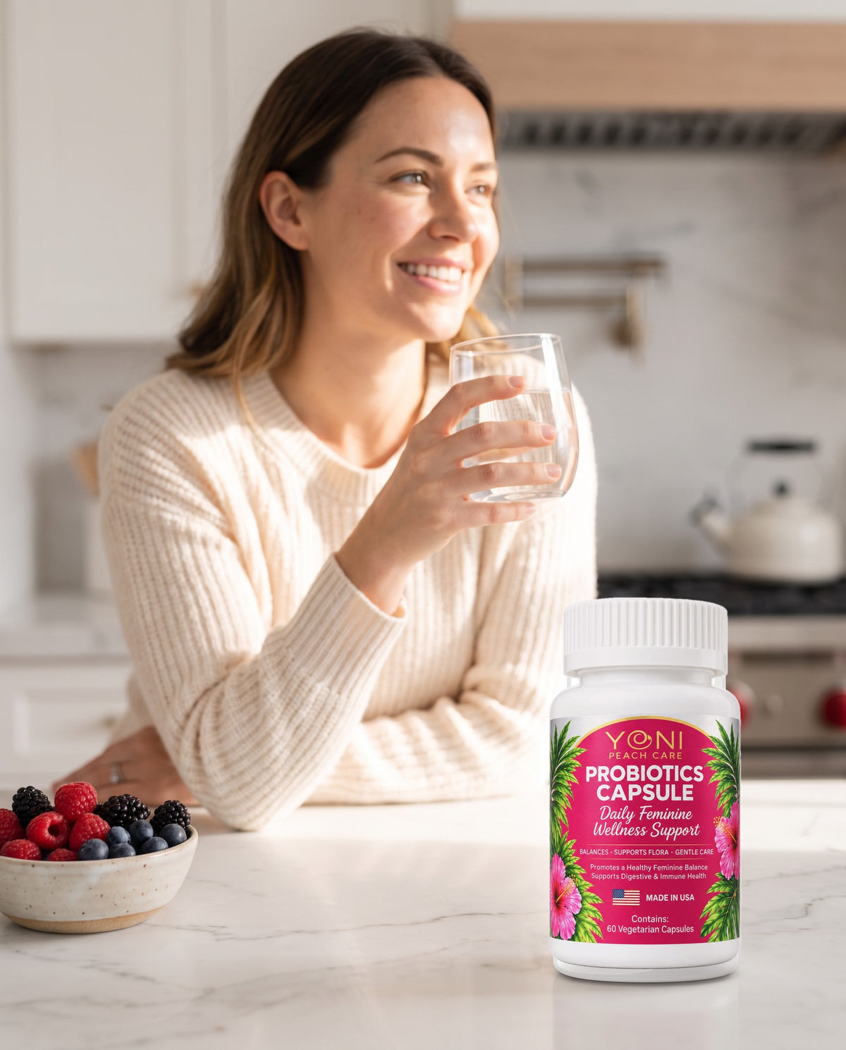 Woman drinking water in a bright kitchen with Blissful Balance women's probiotic capsules bottle on the counter